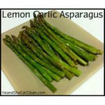 asparagus on a beige plate text reads lemon garlic asparagus