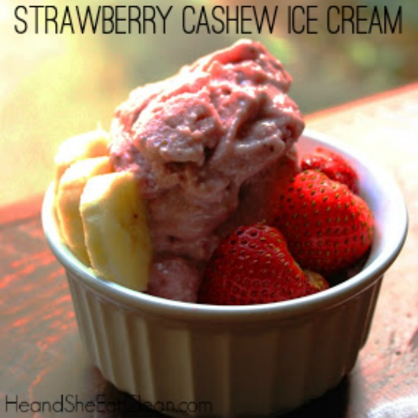 strawberry ice cream with strawberries and bananas in a small white bowl