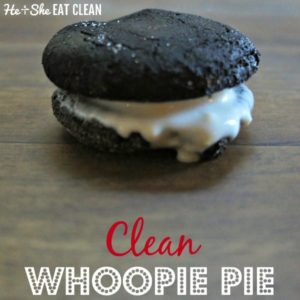 whoopie pie cookie with white frosting in the middle on a wooden table