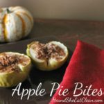 two green apples topped with oat and cinnamon on a brown plate with a red napkin