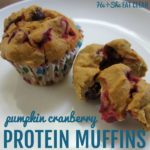 square image of two pumpkin cranberry muffins on a white plate with text that reads pumpkin cranberry protein muffins