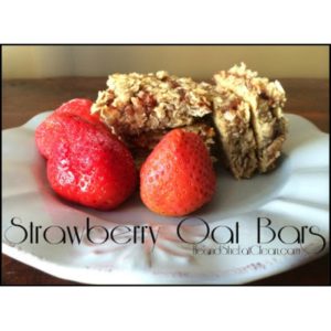 Strawberry Oat Bars on a white plate with strawberries