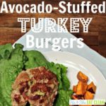 avocado-stuffed turkey burgers with lettuce and sweet potato cubes on a white plate square image