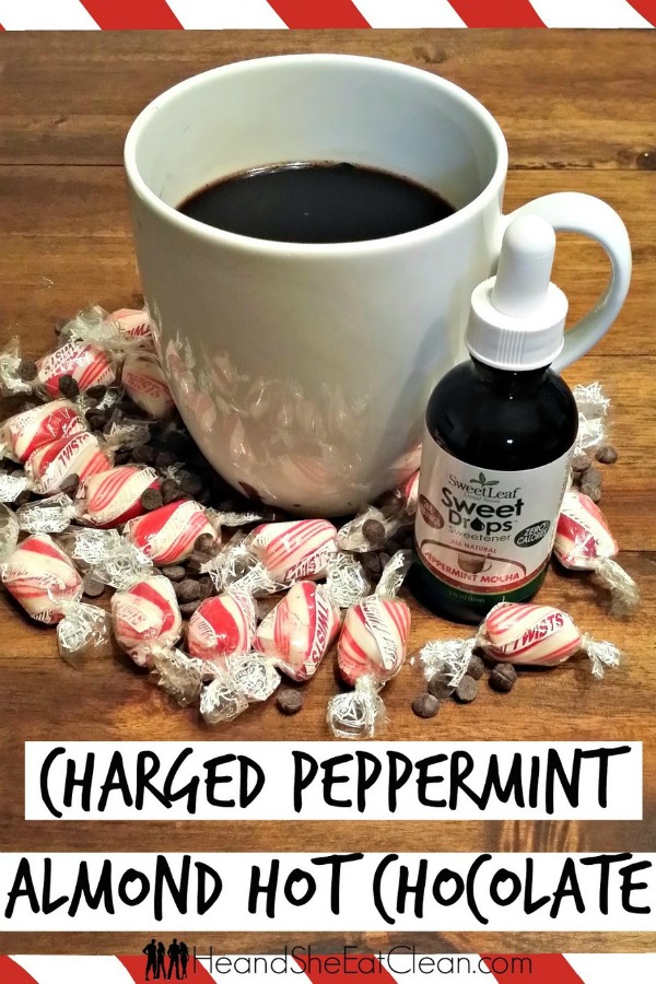 white mug full of coffee on a wooden table surrounded by peppermints