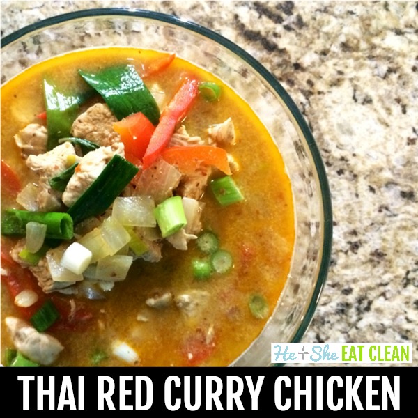 clear bowl of thai red curry chicken sitting on a beige granite slab