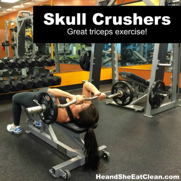 woman lying on a bench doing a skull crushers exercise