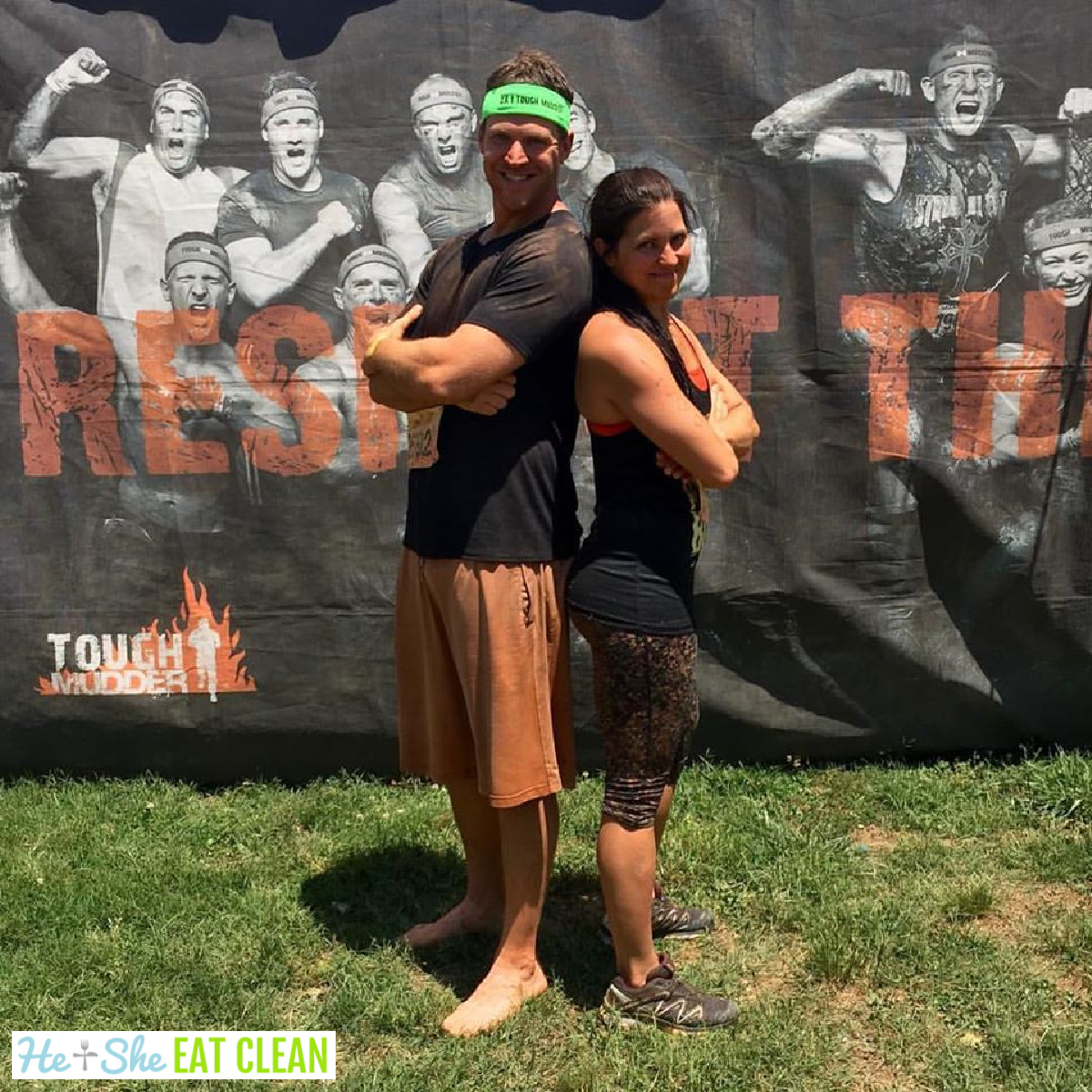 male and female standing back to back after the Tough Mudder race