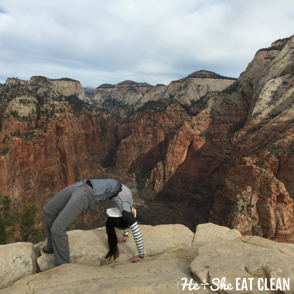 female doing a backbend on top of Angels Landing in Zion National Park