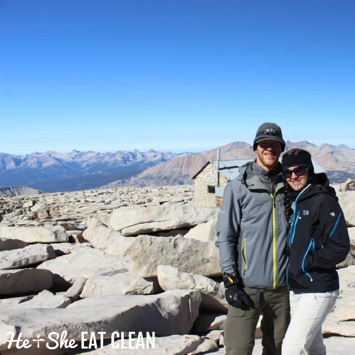 male and female hiker standing on the top of mount whitney in California