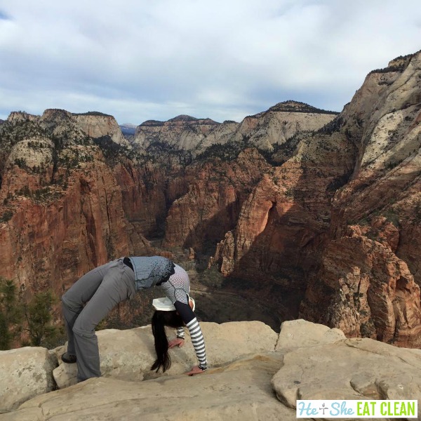 female doing a backbend on the Angels Landing Trail in Zion National Park