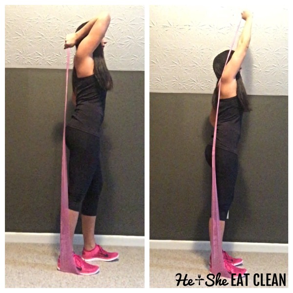 female doing tricep extensions with resistance band
