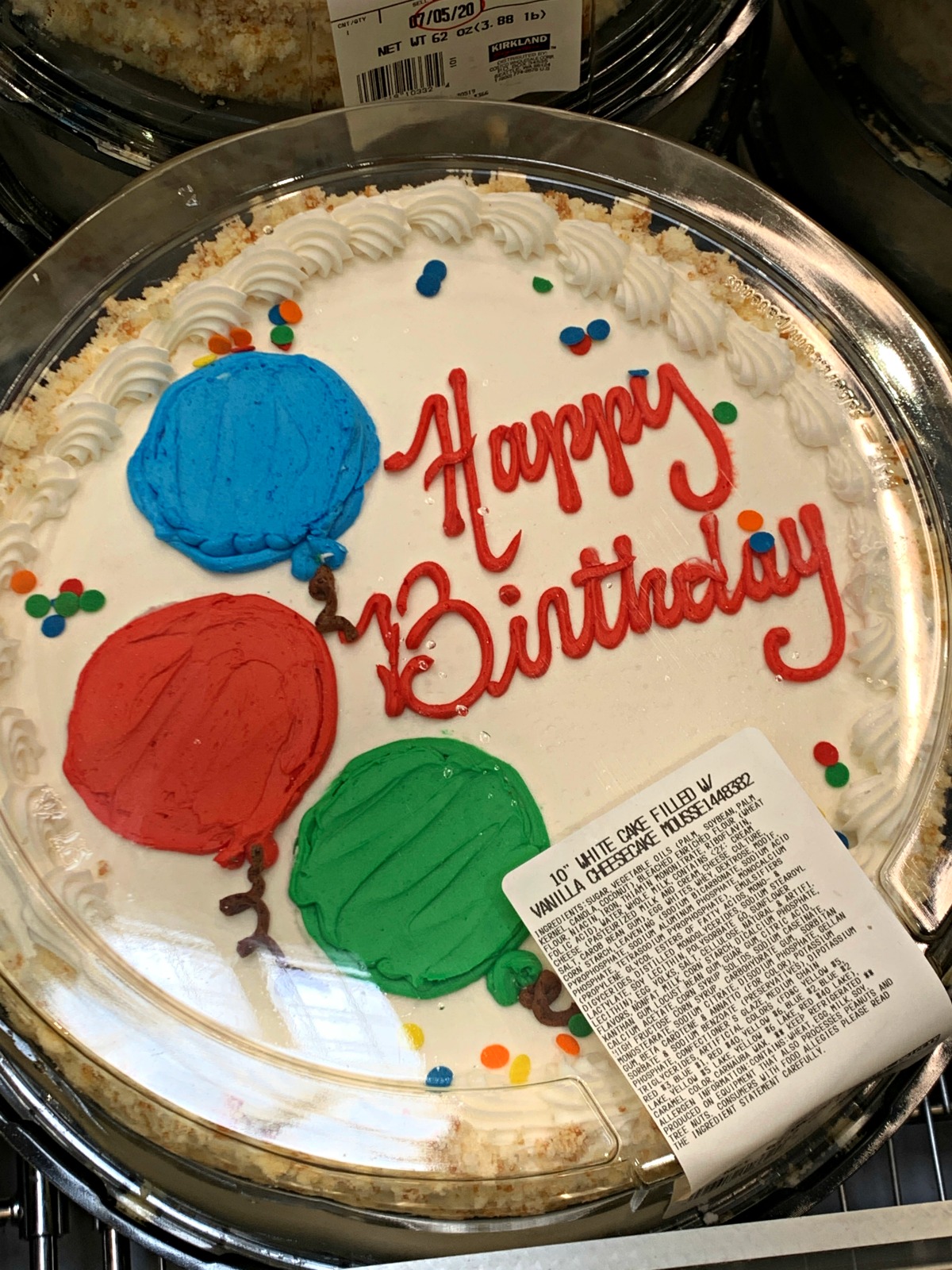 vanilla white cake from Costco that reads Happy Birthday with balloons