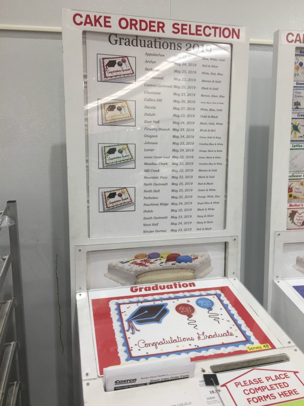 sheet cake with balloons and a graduation cap in a cake ordering kiosk