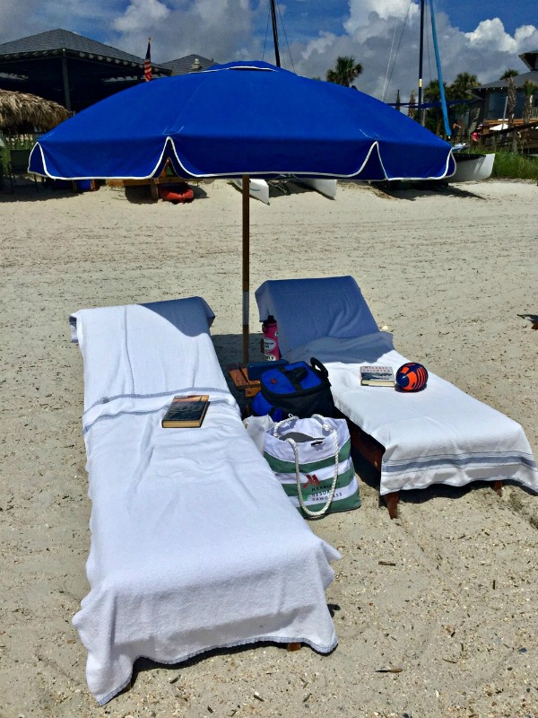 two beach chairs and an umbrella at Sawgrass Marriott Golf Resort & Spa