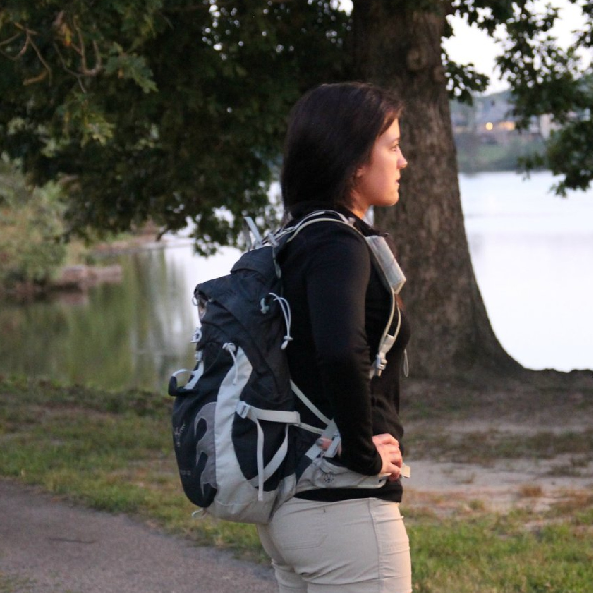 female looking into the distance wearing a hiking pack