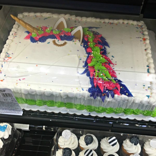unicorn sheet cake from Sam's Club white cake with pink, purple, & green icing