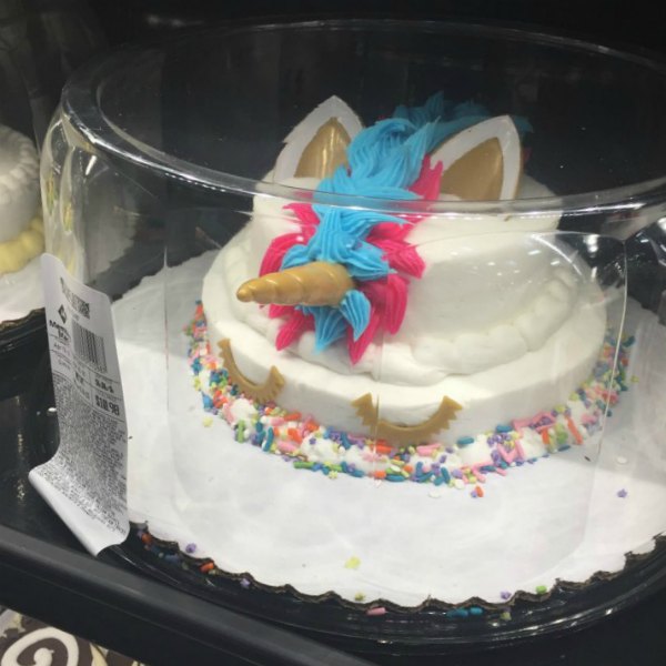 pink & blue unicorn small two tier cake from Sam's Club white cake with pink & blue icing with sprinkles on the bottom
