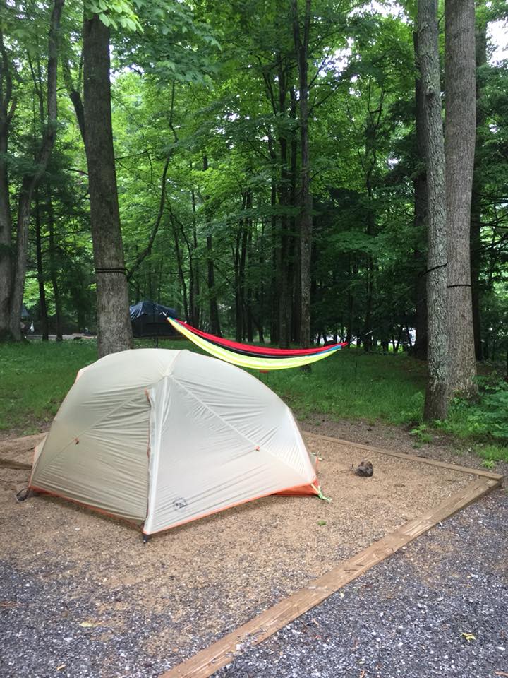 tent and hammock set up on a camping pad in the trees