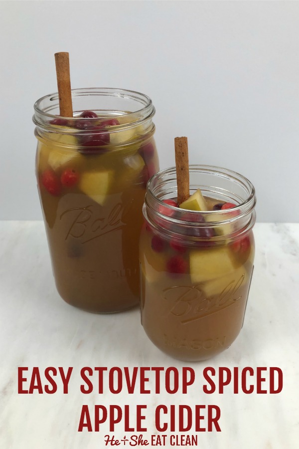 two mason jars of spiced apple cider with cinnamon stick and text that reads easy stovetop spiced apple cider