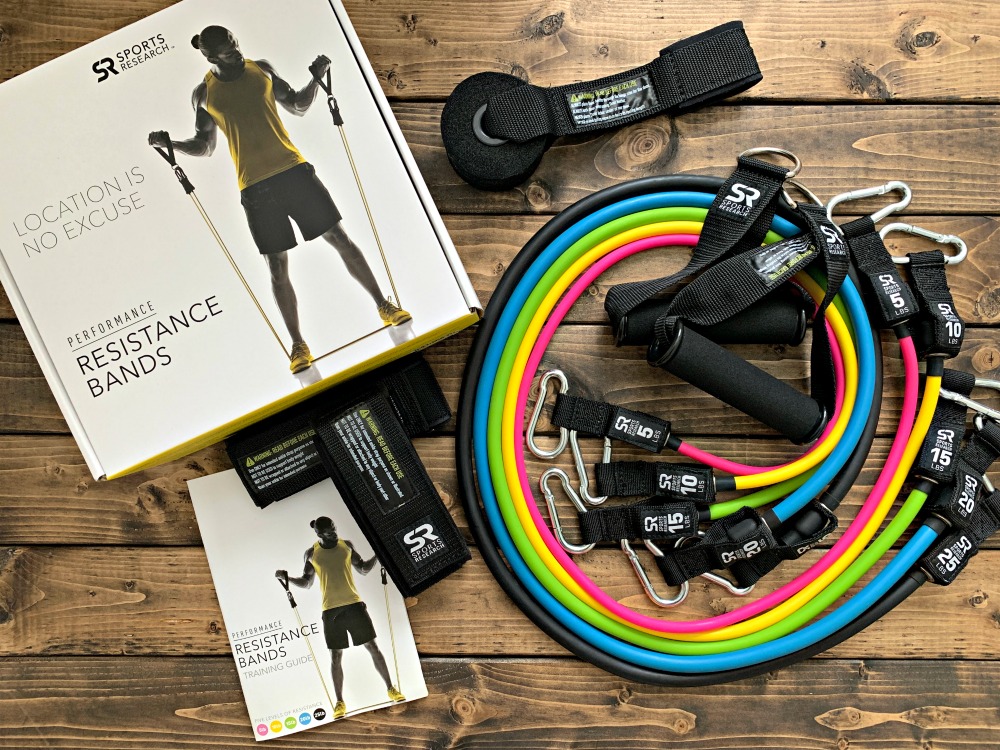 overhead photo of resistance bands, straps, training guide, and box