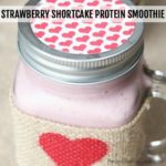 mason jar with lid filled with a pink protein shake - flavor is Strawberry Shortcake square image