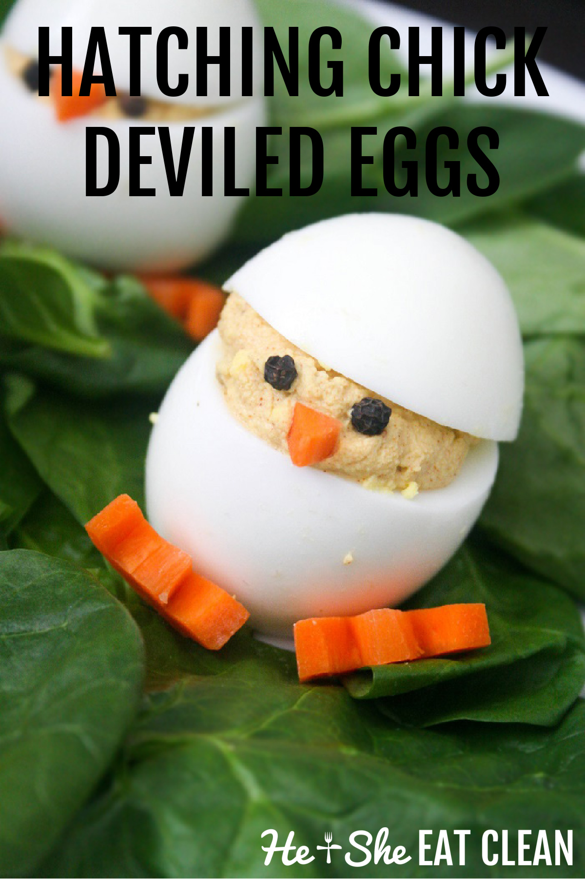 deviled egg made to look like a chick with carrot feet and peppercorn eyes on a bed of spinach