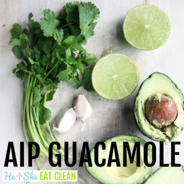 ingredients for guacamole on a white countertop (avocado sliced open, lime, cilantro, garlic)