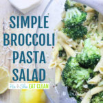 pasta salad with broccoli in a bowl with lemon and cheese on the side