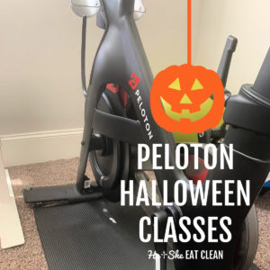 Peloton bike on a black yoga mat with text that reads Peloton Halloween Classes with a pumpkin overlay hanging square image