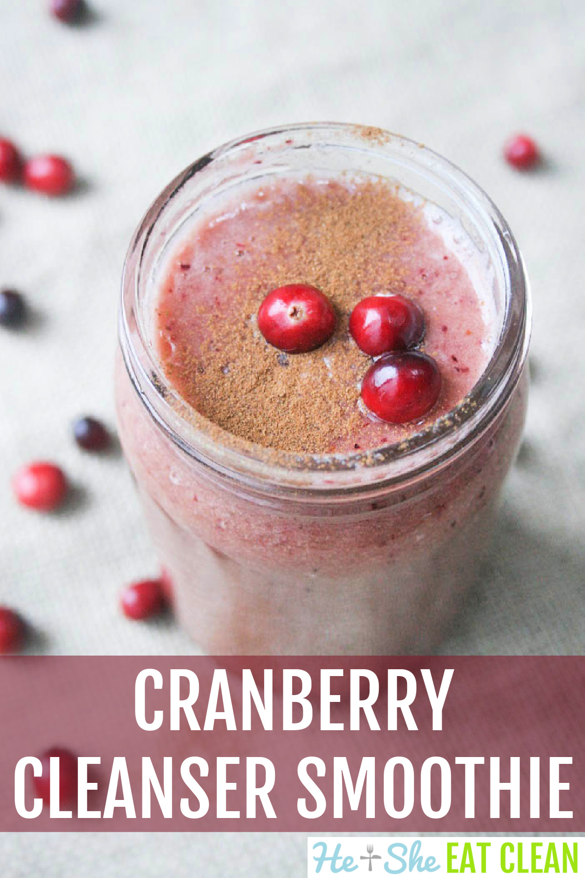 cranberry smoothie in a mason jar with cinnamon and fresh cranberries on top