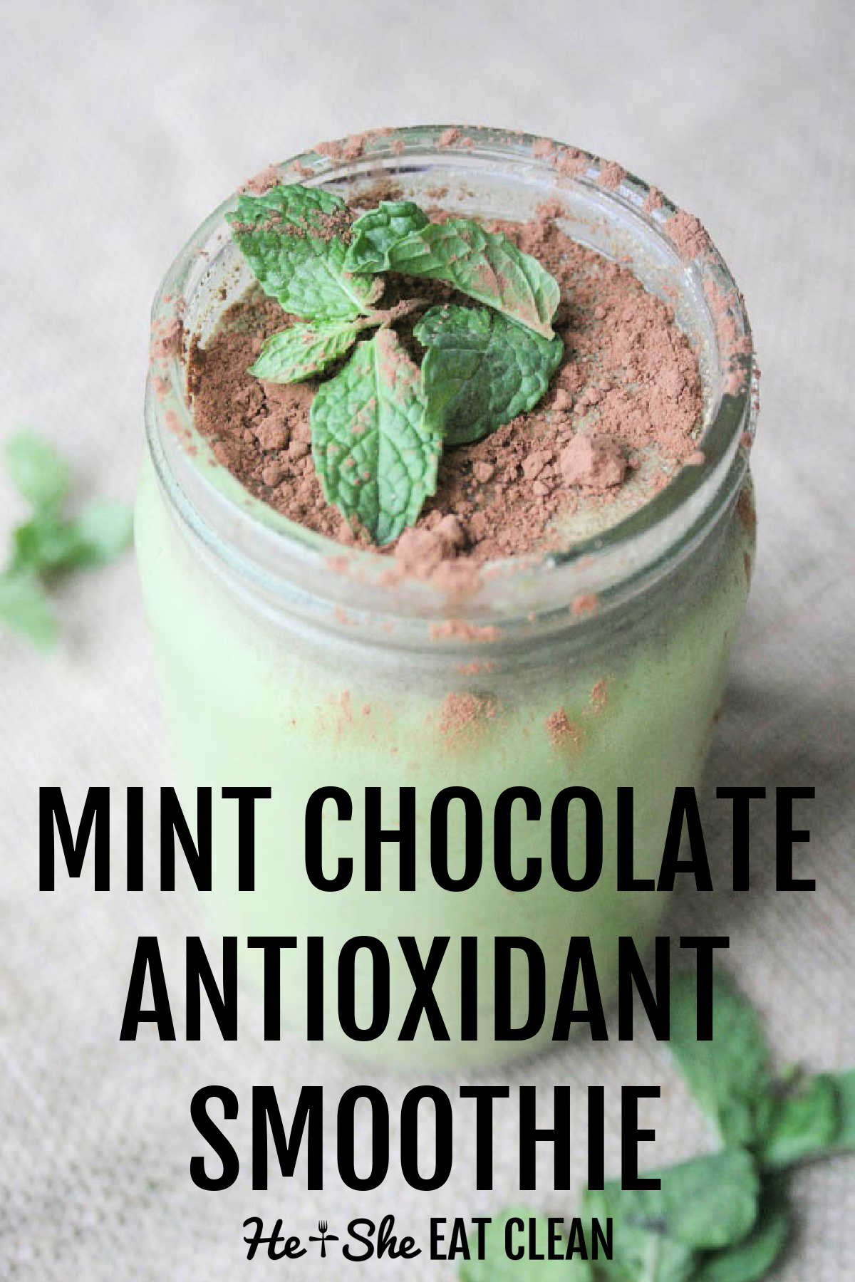 clear jar of green quick with cocoa powder and a mint leaf on top